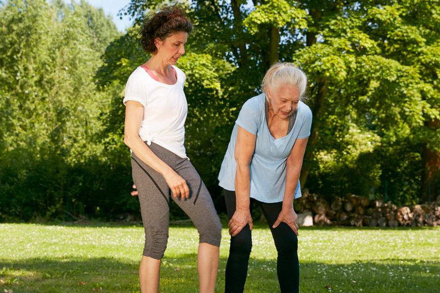 Two elderly women working out in the park