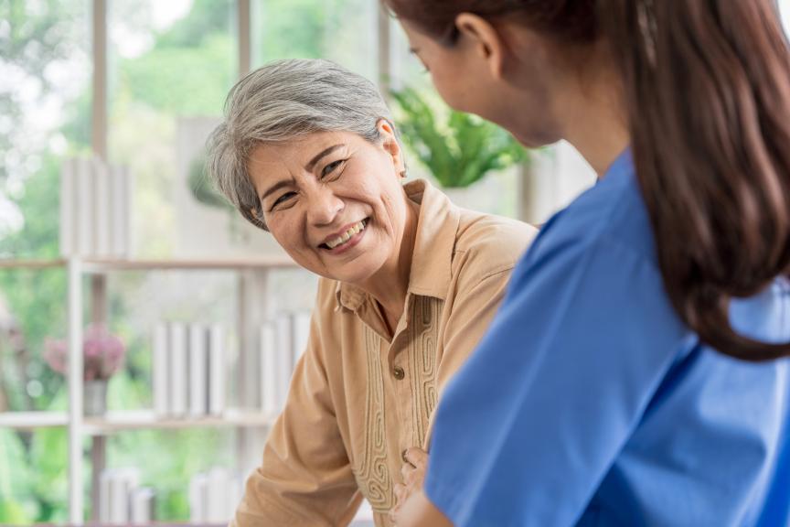 Smiling elderly woman with health care professional