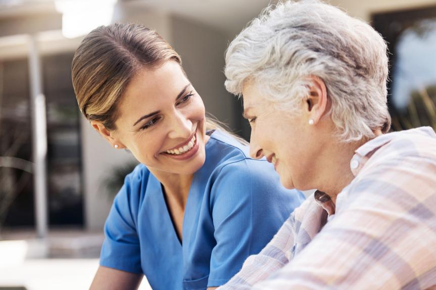 Shot of a happy senior woman and her nurse sitting on the porch at home together