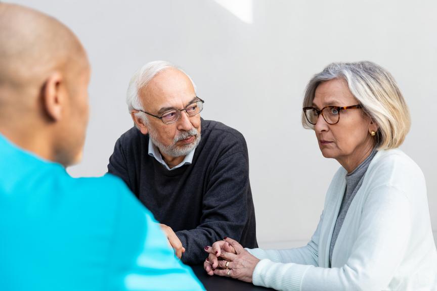 A man and a woman talking to a doctor