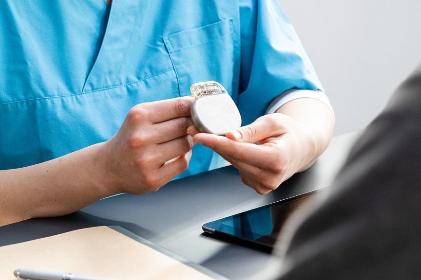 Female doctor holding an implantable defibrillator