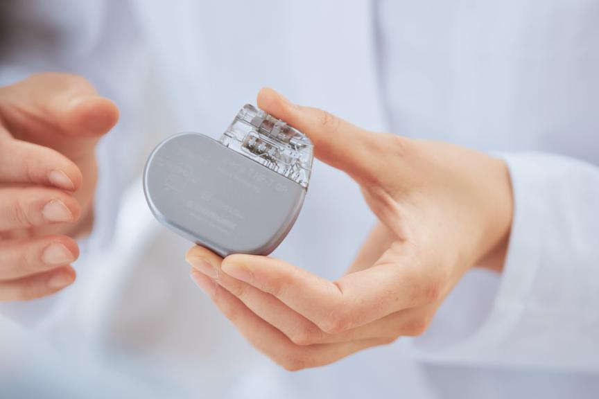 Physician holding a BIOTRONIK device in her hands