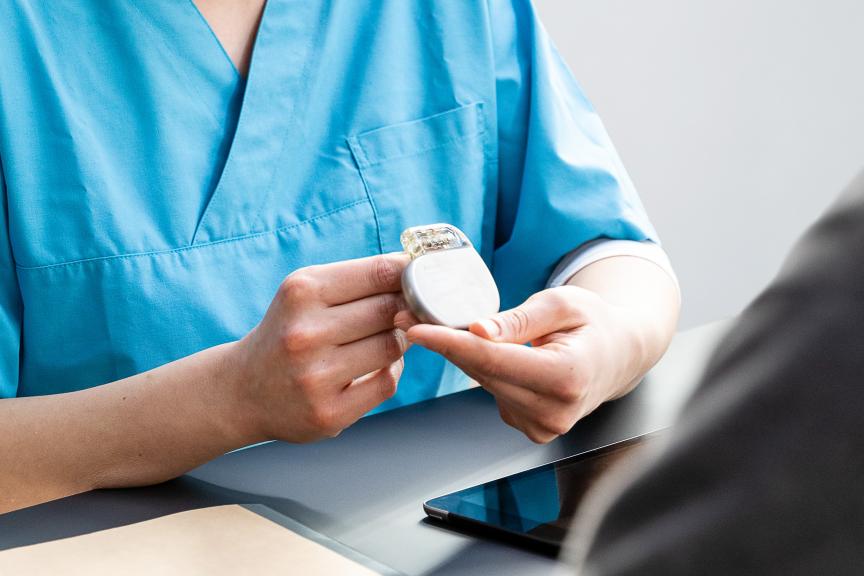 Female physcian holding a BIOTRONIK device in her hands