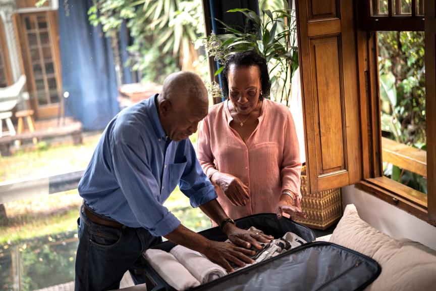 Elderly couple packing their bags