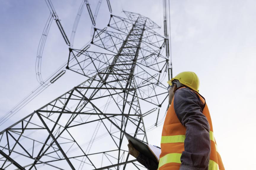 Man at the bottom on a utility pole