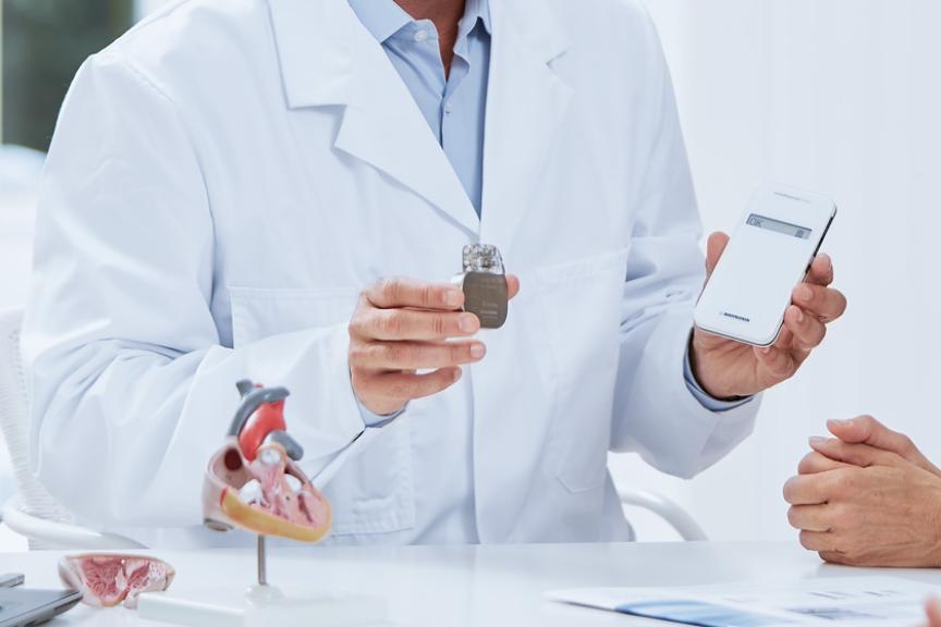 Doctor holding heart devices in his hands