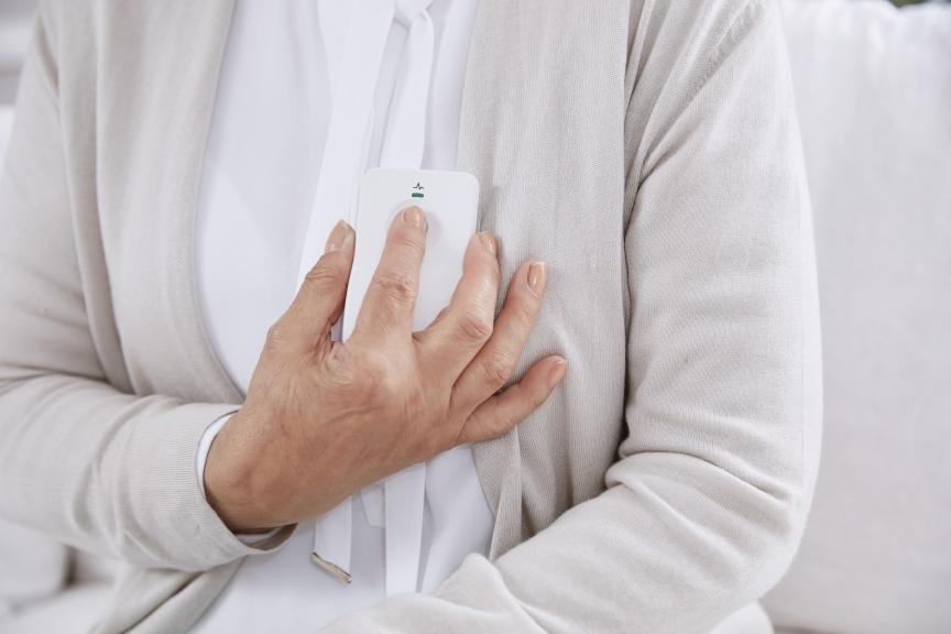 Woman holding device to her heart