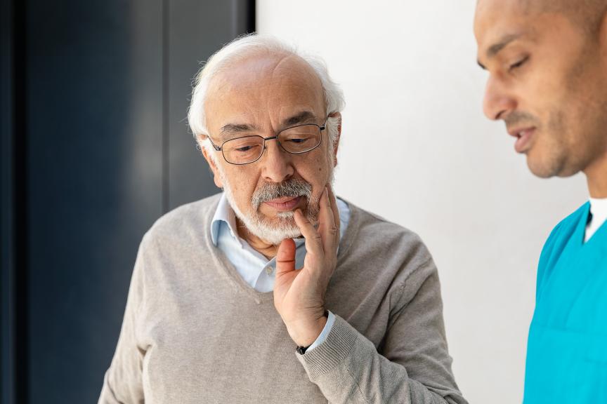Elderly man with health care professional