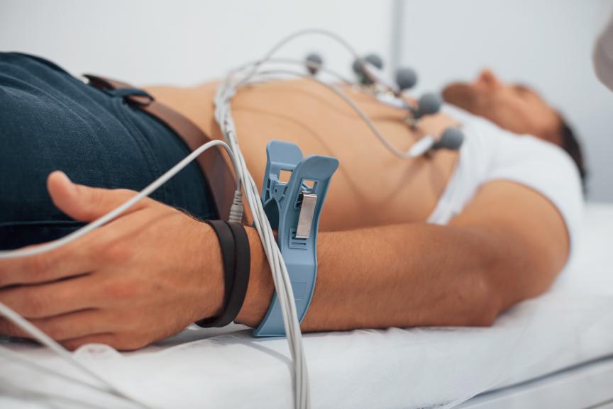 A man laying down getting an ECG