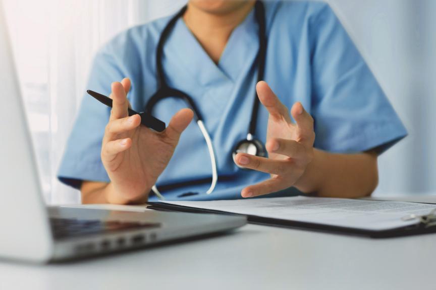 Physician's hands with a pen in their hand