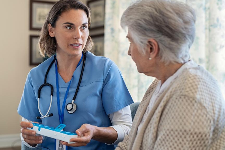 Felame physician talking to an elderly female patient