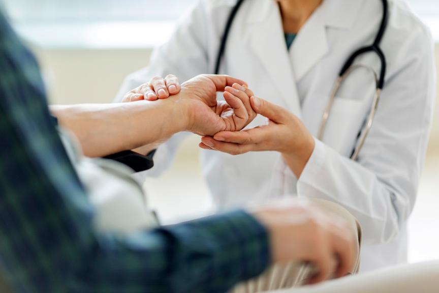 Physician taking pulse measurements by hand