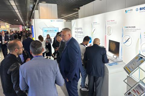 Multiple people at a conference booth